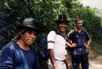 Two Ixil Indians from Caba walk with a Spanish acompañante, who is a member of a foreign solidarity group. Originally, the acompañantes flew to Guatemala to protect local revolutionaries from army forces. The need for protection has lessened and this foreign visitor is walking with the Indians to a nearby folk holiday.