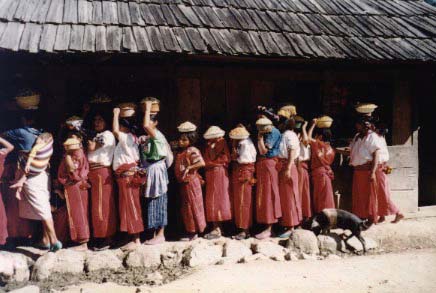 Ixil women stand in line in Caba to have corn ground.