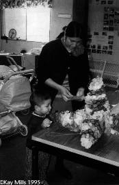 Hilaria Guerrero works on a craft project at the parent center at McKinlley School while her son looks on.