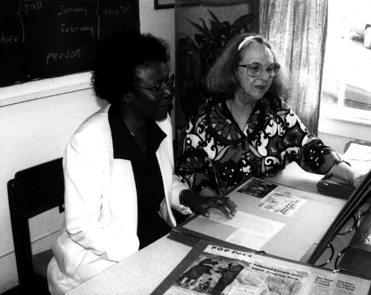 Frankie King (left), human services coordinatory for the Alabama Council on Human Relations Head Start program, and director Nancy Spears scan a scrapbook of the program's history.