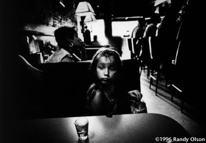 Alone and confused, Melody, 8, follows her grieving mother into a bar across from the funeral home where her twin sister's body was handled. Melody doesn't outwardly dwell on the fact that she, too, has AIDS, but she will tell anyone who asks that she probably won't live much longer.