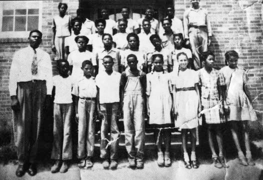 Willie Brown stands second from the left, next to his teacher, Claude Adam, in this 8th and 9th grade class photo at Mineola (Texas) Colored School, probably in 1942. Photo Courtesy of Virginia McCalla.