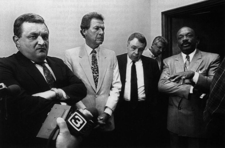 Legislative leaders emerge from tense budget talks with Republican Governor George Deukmejian in his office in 1990. From left, Democrat David Roberti, the state Senate President Pro Tempore; Republican Ken Maddy, the Senate Republican Leader; Republican Ross Johnson, the Assembly Republican Leader; and Willie Brown, Democratic Assembly Speaker. In the background is the governor's press secretary, Bob Gore. Photo by Louis Bernstein