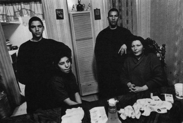 The Quilles family at home, Danny at right, Romero at left and Maria, at left, sitting.