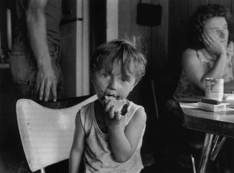 Justin Avery of West Athens, Maine, eats his third piece of chocolate cake. The baker, his grandmother, Phyllis Avery, sits in the background. APF Fellow Steven Rubin photographed the eating habits of young and old in this rural hamlet, finding that wholesome food is in short supply.