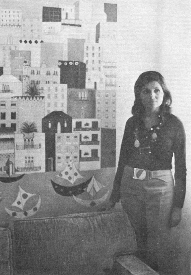 Palestinian artist – Jumaina Husseini Bayazid stands next to one of her Paintings, a gay, two dimensional rendering of her adopted home, Beirut.