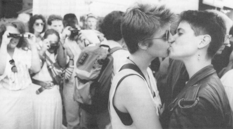 Queer Nation members kiss for the tourists’ cameras on Fisherman’s Wharf in San Francisco.
