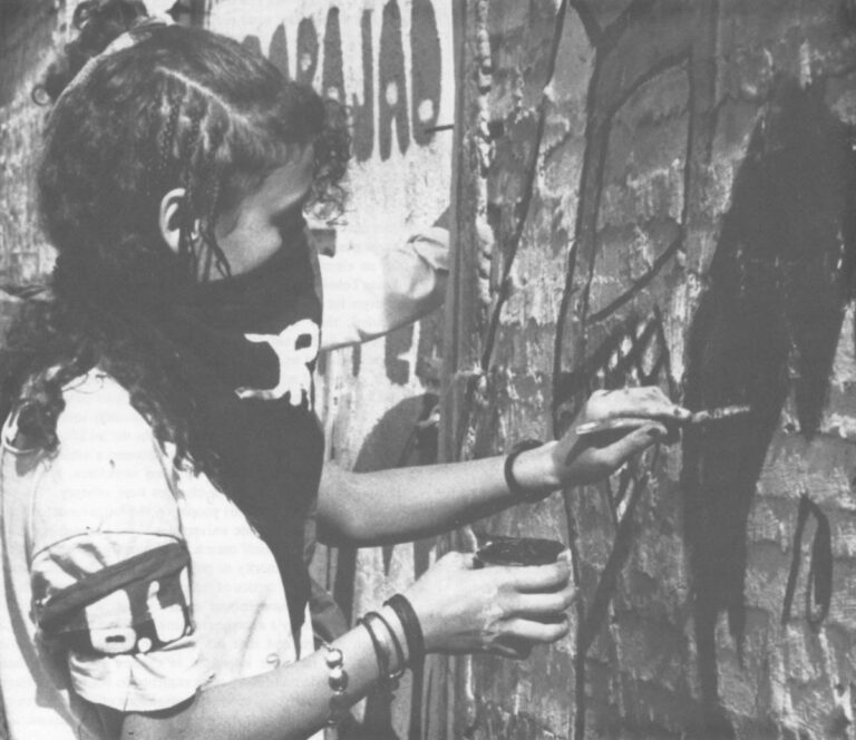 A member of the Revolutionary Artists’ Brigade painting a mural. Photo by Pamela Constable.