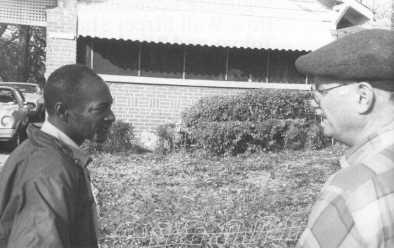 James Hogan (left) stands in front of his home with William Brennan Jr., a Legal Aid Lawyer who directs DeKalb County’s Home Protection Program. Photo by APF Fellow Michael Hudson