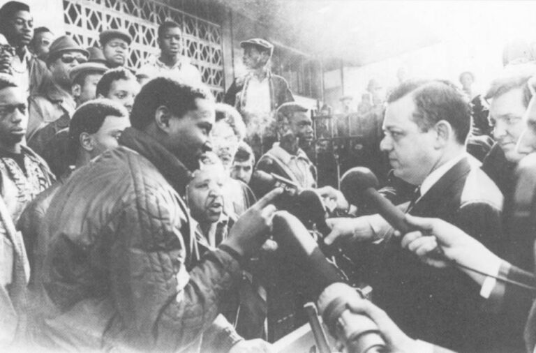 In the fall of 1968, Sonny Carson and his supporters began establishing local governing boards which "dismissed" white teachers from predominately black schools. Here, teacher Fred Nauman is blocked by demonstrators outside Junior High School 271 in Brooklyn after Nauman and four others were "dismissed." AP/Wide World Photo.
