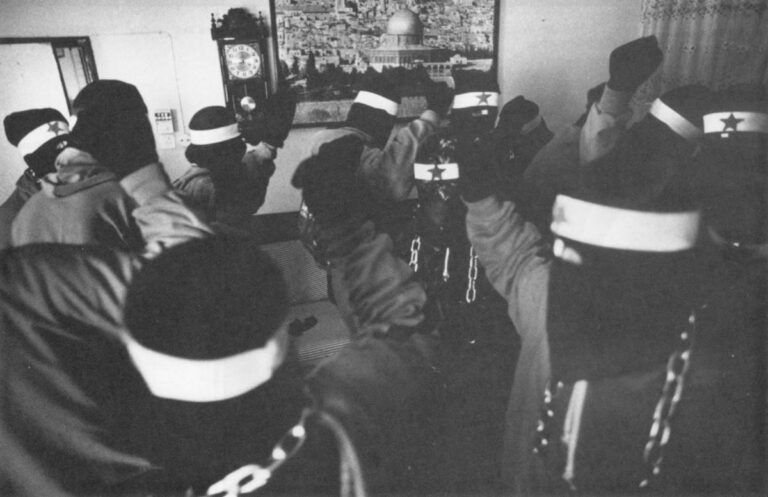 Members of the Omar Kassam paramilitary brigade gather in a living room in the Tulkarm Refugee Camp to renew their allegiance to the P.L.O. and the "Unified Leadership" of the uprising. The brigade is named after a Palestinian revolutionary who spent 21 years in an Israeli prison until his death.
