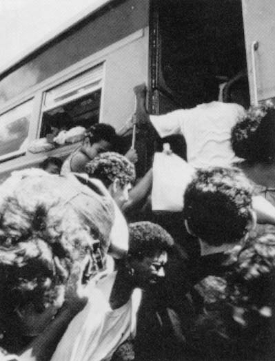 Would-be passengers at the Acailandia stop of the Sao Luiz-Carajas railway scramble to find space on the jammed train. The tide of settlers exploiting the Amazon’s resources has made Acailandia one of the fastest growing cities on the earth.  Photo By Andrew Posner ©1991
