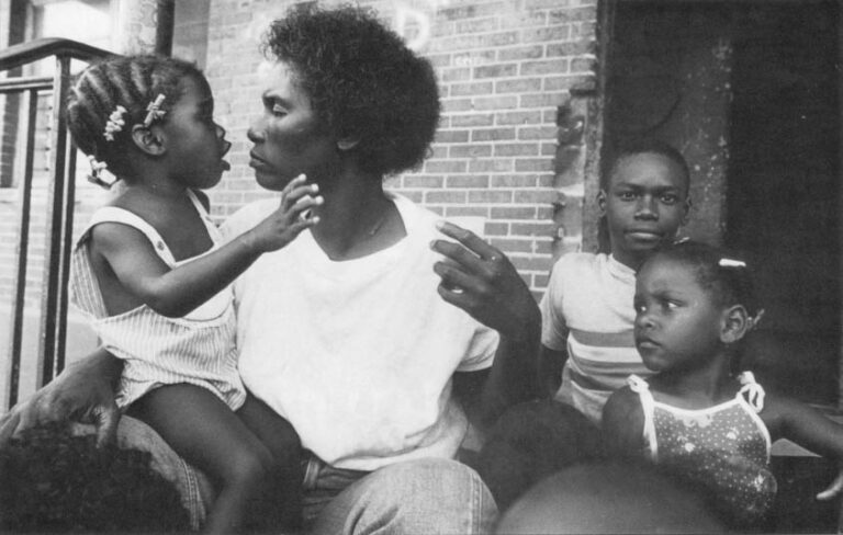 Connie Taylor and three of her eight children. They live in a housing project owned by the city of New Orleans, Louisiana.