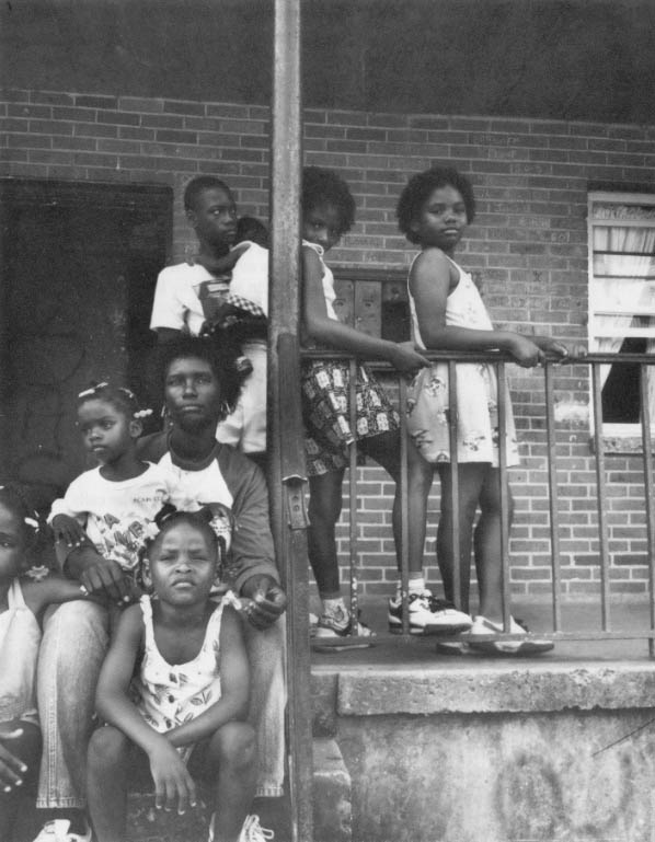 Residents of the apartments owned by the New Orleans housing authority pose on the front porch.