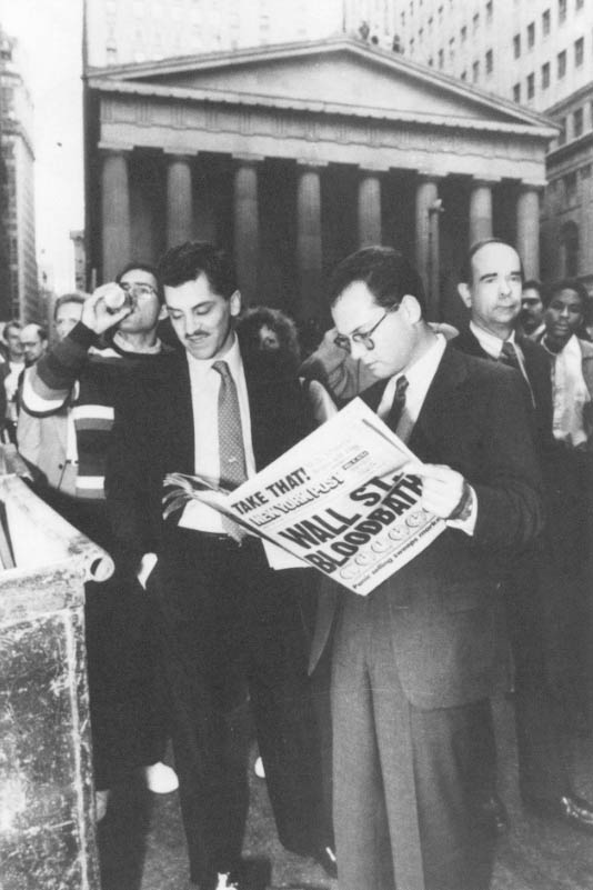 Bystanders near the New York Stock Exchange read newspapers headlining record losses in the Dow Jones Industrial average as a barrage of panic-selling hit the N.Y.S.E. on Black Monday 1987. AP Wide World Photo