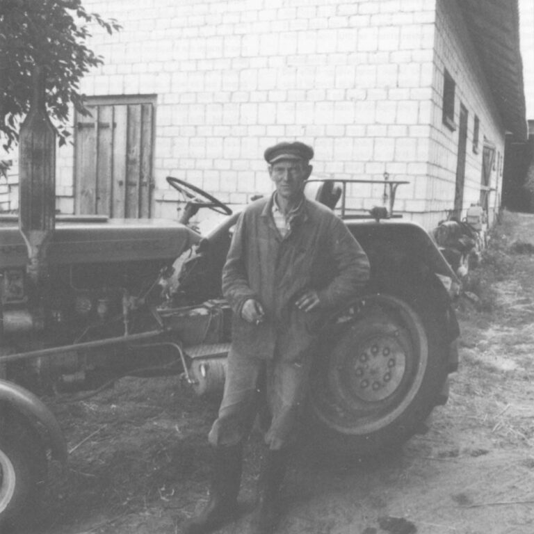 Henry Kowalewicz, 53 stands next to his tractor, which is idle for lack of parts.
