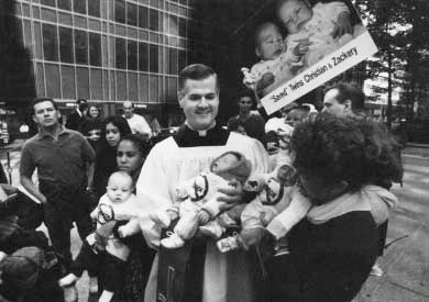 Gerald Murry and Kathy DeFiore, right, founder of Several Sources Foundation, an anti-abortion group, hold twins Christian and Zackery at a rally in New York in 1991-they said the twins were saved when members of the group persuaded their mother not to end her pregnancy. Photo by AP Wideworld Photos.