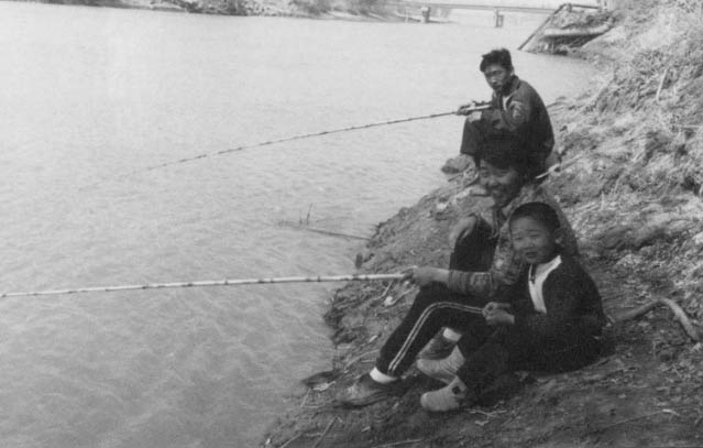 Children also fish the canal in Nukus, into which the irrigation ditches drain.