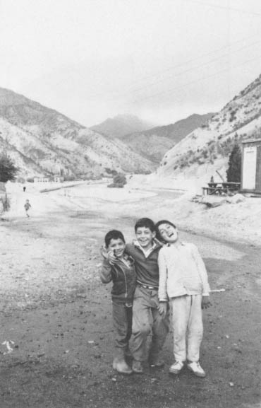 Three children laugh at the Felix Dzerzhinsky State Farm (Sovkhoz) in Gissarskiy District, about 15 miles southwest of Dushanbe. Cotton is grown, and heavily irrigated.