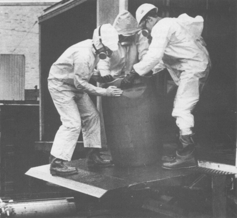 Federal workmen load barrels of toxic waste to be disposed. Photo by Joel Richardson, courtesy of The Washington Post.