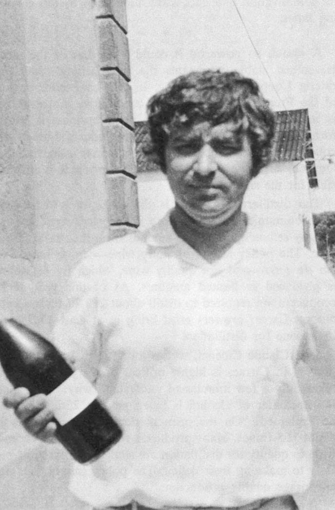 Jean Claude Cibenel with a bottle of local wine.
