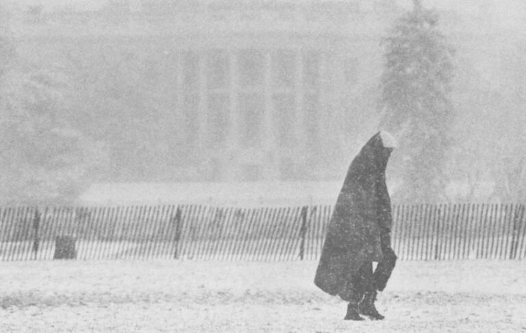 Homeless man wanders past White House.