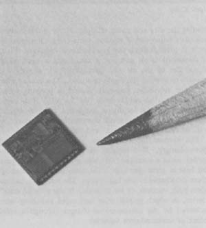 The single-chip microprocessor packs all the elements of a computer into an area less than one-quarter inch square. Photo courtesy of Texas Instruments