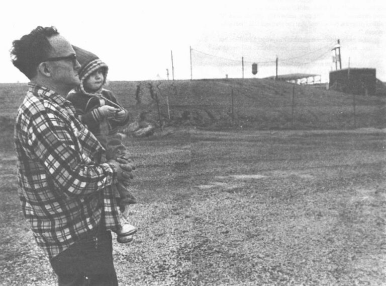 Fred Armagost (above, with his granddaughter), lives a few feet from Bloody Run Creek near the Hyde Park dumpsite. A negotiated cleanup agreement between the government and Hooker Chemical Company at this site is being delayed by local residents who are convinced that their health and safety were shortchanged by the agreement. Wide World Photo