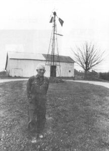 Old man, barn and windmill