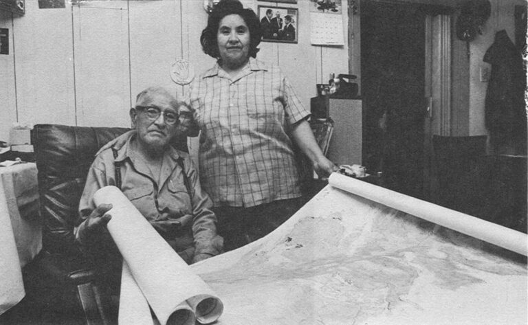 Lydia and Jimmie George with land maps.