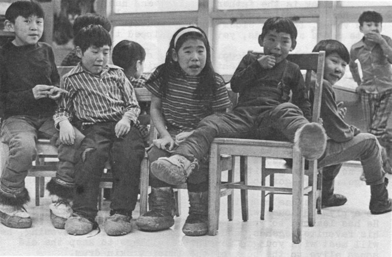 Anything New delights the Anaktuvuk youngsters. Above, Simon Paneak's son, Harold, and granddaughter, Vickey, check out the writer's cassette recorder which ia a newer model than Simon's. Below, a game of musical chairs at a school party.