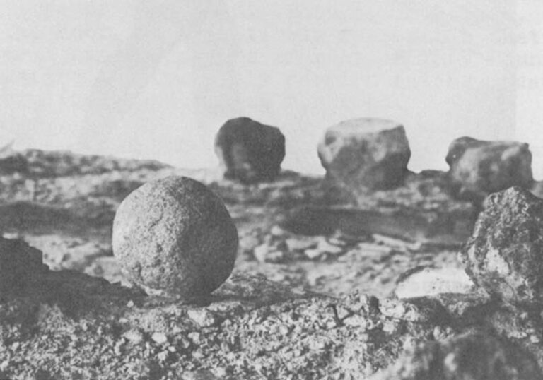 One of the more nearly spherical stones. Probably not a "bolas stone," it appears to have been worn smooth by grinding. It may have been used to mash roots against a flat "anvil stone" such as the middle one in the background.