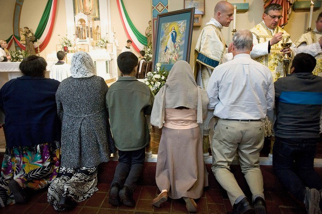 Parishioners receive Holy Communion at a traditional Latin Mass held at Our Lady of Guadalupe church in San Diego, CA> PHOTOS BY DAVID MAUNG.