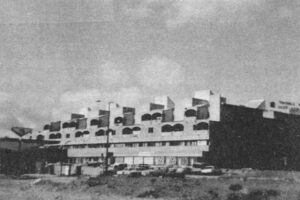 "Pyramid" structure of housing, offices and stores in Beersheva. Note in upper right view, on right side of building, opening to inside arcade. Other views show mall and supermarket appendage on building's other end.