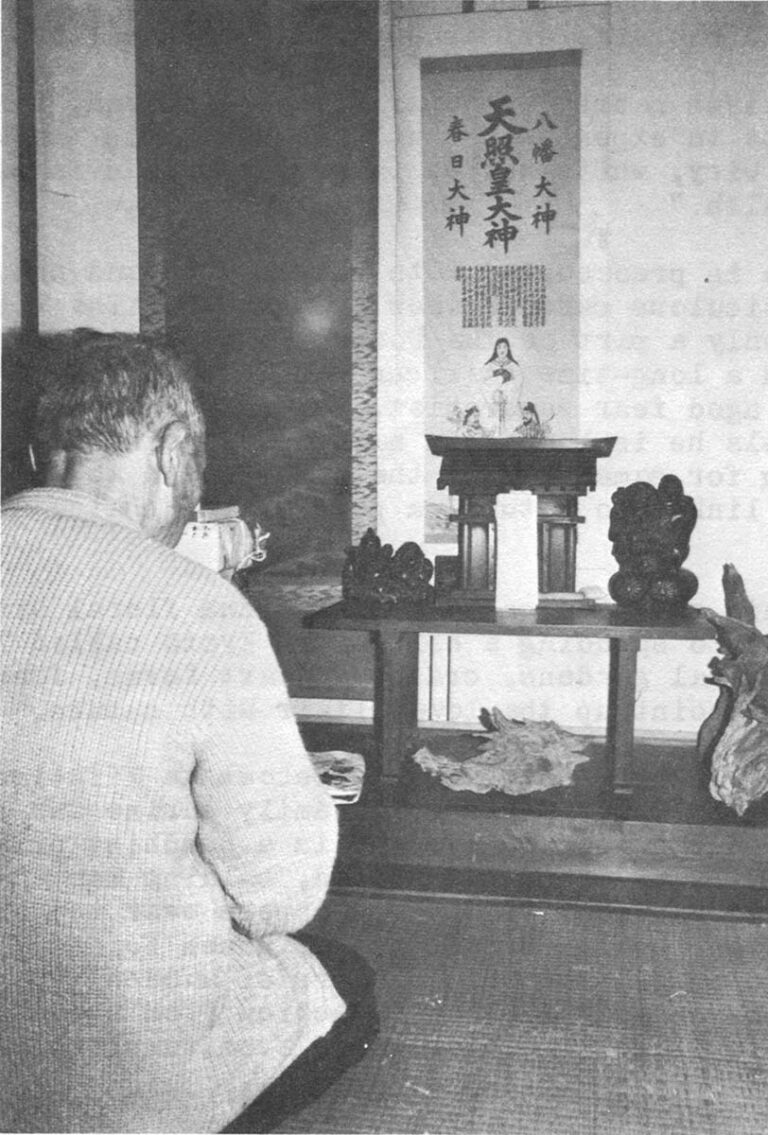 Mr. Hoso at his family shrine decorated with driftwood "sculpture."