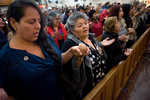 Parishioners pray during Mass at the Our Lady of Guadalupe church in the Barrio Logan neighborhood of San Diego. PHOTO BY DAVID MAUNG.