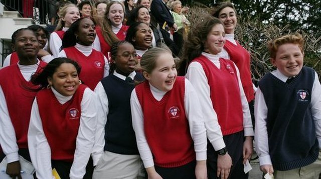 Young Catholic school students react as they watch the arrival of Marine One to the South Lawn of the White House in 2006. At the time 2.5 million students attended Catholic schools; today the number is 1.6 million, and lay teachers have almost completely replaced nuns and priests. Fewer young adults today have had a Catholic education. White House photo by Paul Morse, from Wikicommons.