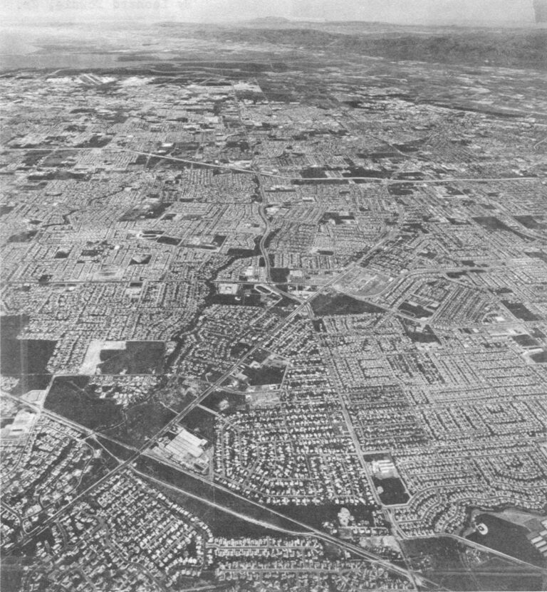 The fulfillment of the Santa Clara Valley's "appointment with destiny": sixteen cities of roofed boxes and concrete strips wrapped around each other with no sense of community or vestige of natural beauty. Looking north, note the San Francisco Bay at top left and mountain ridge at top right.