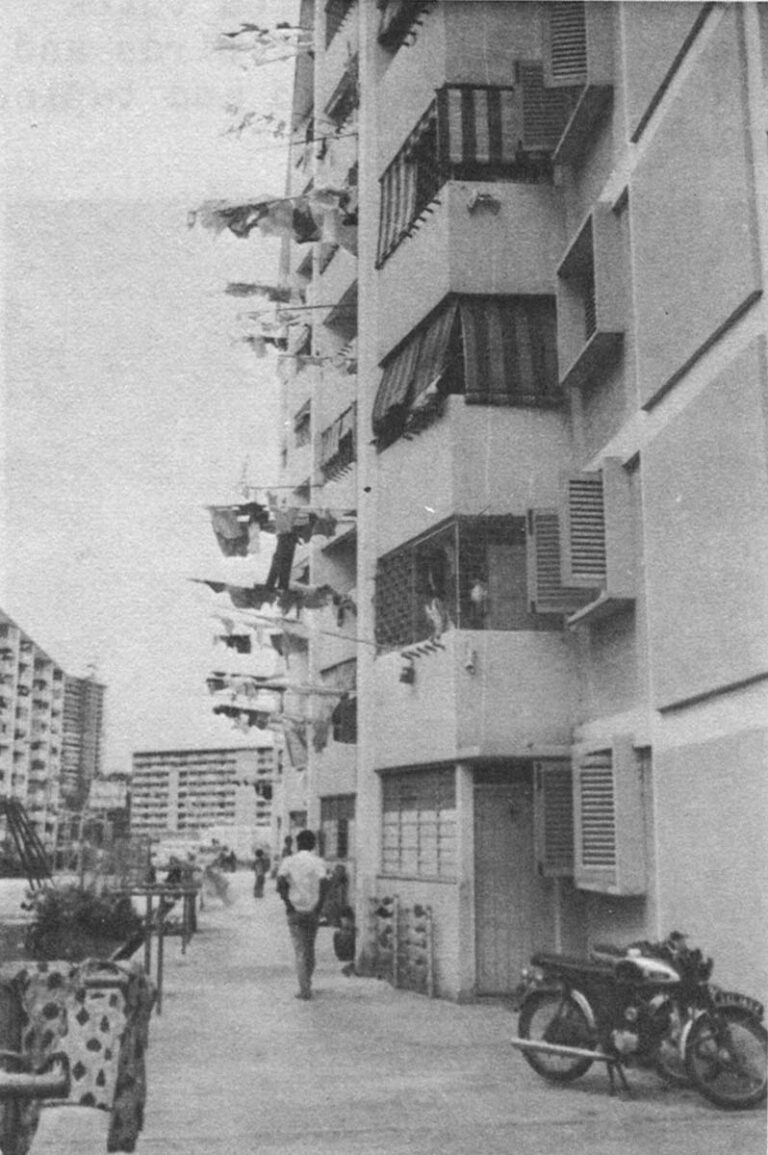 Typical apartment building with clothes drying on suspended sticks (resembling skewered meat ready for barbecue).