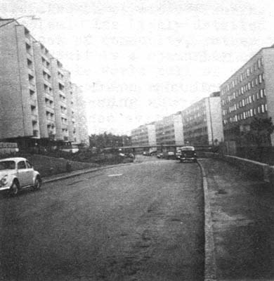 Long, stark lines of apartment buildings on hill behind Skärholmen center.