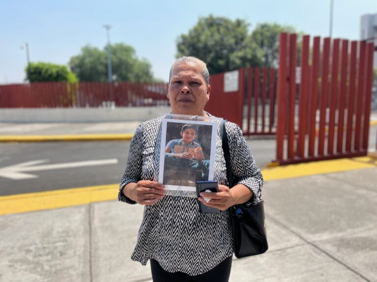 María Zapata Escamilla stands outside Mexico's Congress holding a photo of her missing son. Credit: Oscar Lopez