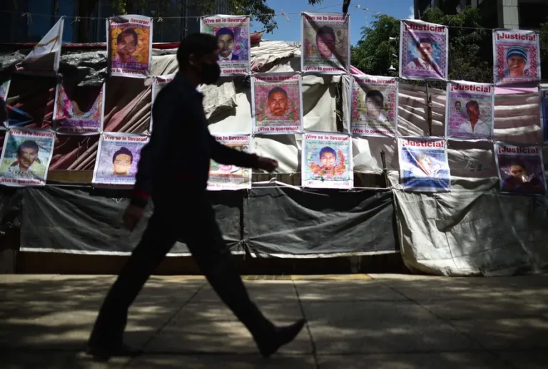 A man walks in front of the memorial site for the 43 missing students from the Ayotzinapa normal school in Mexico City, on 23 August 2022. Photograph: Rodrigo Arangua/AFP/Getty Images