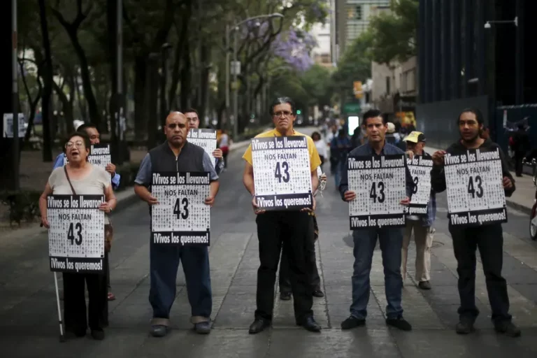Activists hold signs to demand justice for the 43 missing students of Ayotzinapa Teacher Training College, outside the office of Mexico’s attorney general in Mexico City, 4 April 2016. The signs read: ‘Alive they were taken. Alive we want them.’ Photograph: Edgard Garrido/Reuters