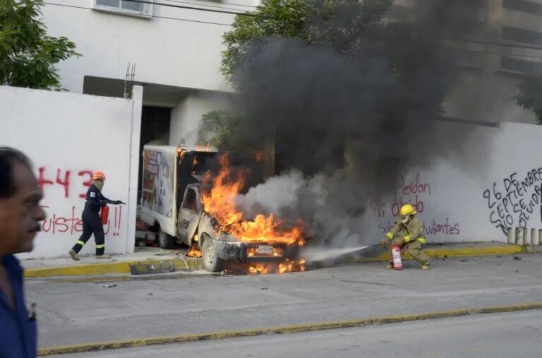 A truck burns at the entrance to the Palacio de Justicia in Iguala in state of Guerrero on September 27, 2022 during a demonstration by students of Ayotzinapa's Normal Rural School to demand justice for the 43 students who disappeared in Iguala 2014. Getty Images