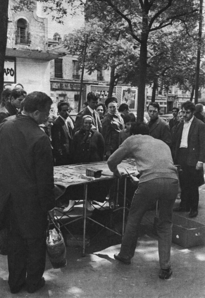 A group gathers, glad to be entertained even by a sales pitch.