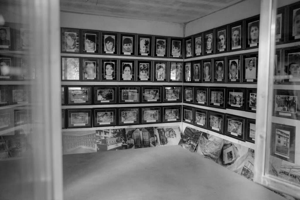 Images of Fadil Muqolli’s family are preserved in their home, where 53 people were killed on April 17, 1999. For the past 24 years, Muqolli has preserved the house as a memorial to his family and to the war that’s open to the public. (Diana Markosian for The Washington Post)