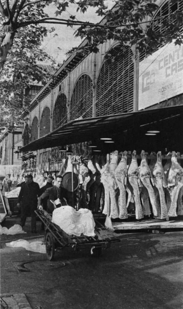 Men bargain in a meat pavilion, one of the last still in use at Les Halles.