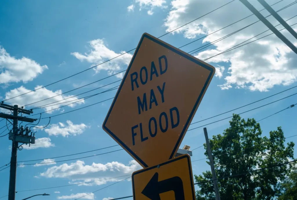 A sign on Brookville Boulevard, or Snake Road, and 149 Avenue in Rosedale, Queens warning drivers of potential flooding. Credit: Damaso Reyes