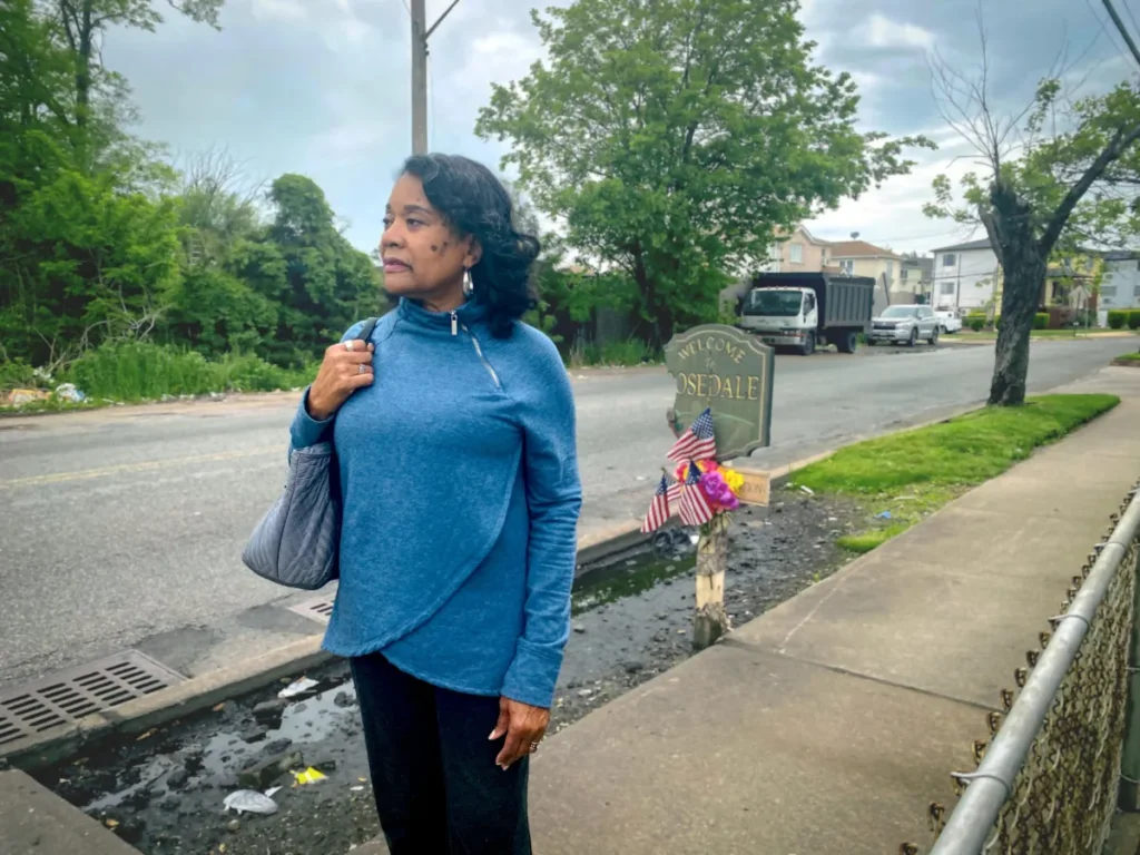 Crystal Brown on Brookville Boulevard, also known as Snake Road. Brown has lived in the nearby Brookville neighborhood since the late 1980s. She moved to the area in order to own a home. In addition to flooding, she’s also concerned about the dumping that goes on in the wetlands. Credit: Roxanne Scott